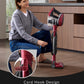 Woman using a red and black vacuum cleaner in a room with wooden flooring.