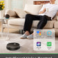 Person sitting on a couch with a coffee cup, surrounded by smart home devices, including a robot vacuum cleaner.